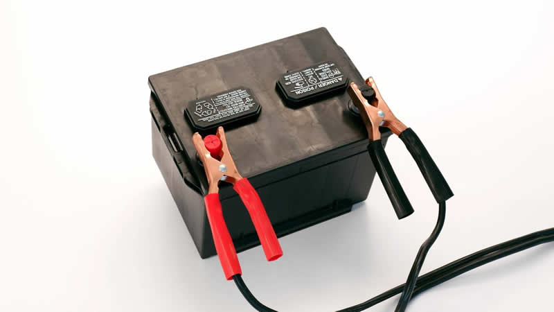 Photo of battery cables connected to a battery - red to positive, black to negative