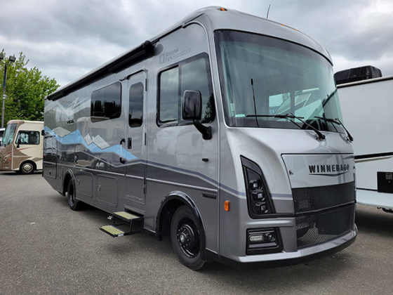 Image of a gray 2023 Winnebago Vista with National Park Foundation mountain range graphics on the side.