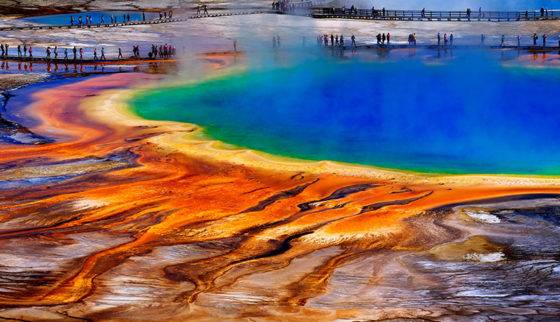 Photo of tourists walking around the Grand Prismatic Spring in Yellowstone National Park